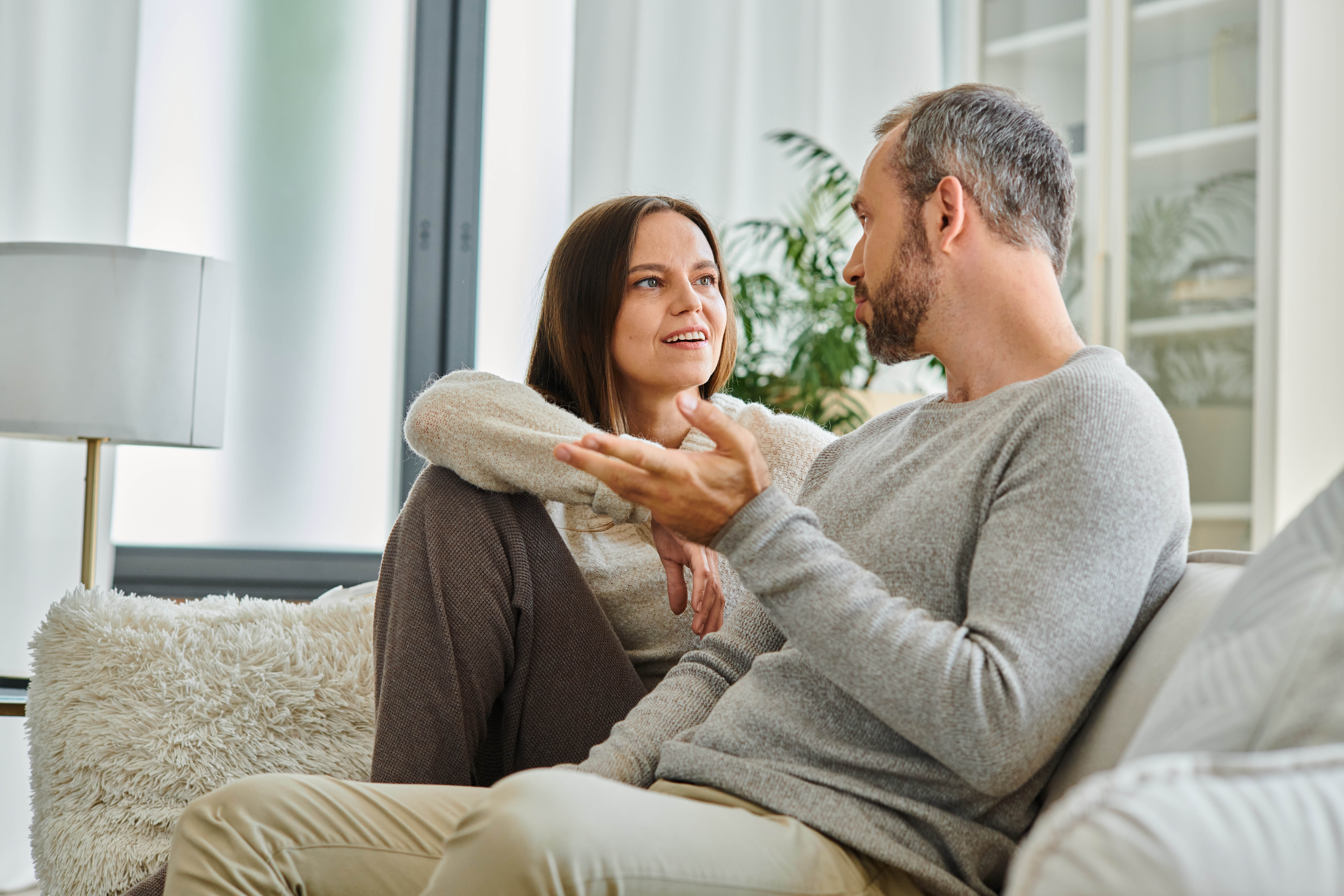 Couple sitting on a couch in deep discussion